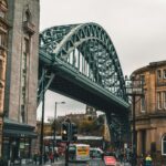 Dynamic urban scene featuring the Tyne Bridge, Newcastle upon Tyne, showcasing local architecture and bustling street life.